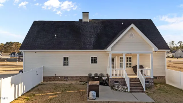 a front view of a house with yard and seating space