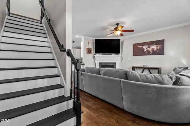 a living room with fireplace furniture and a flat screen tv