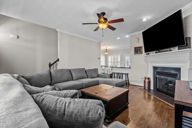 a living room with furniture fireplace and flat screen tv