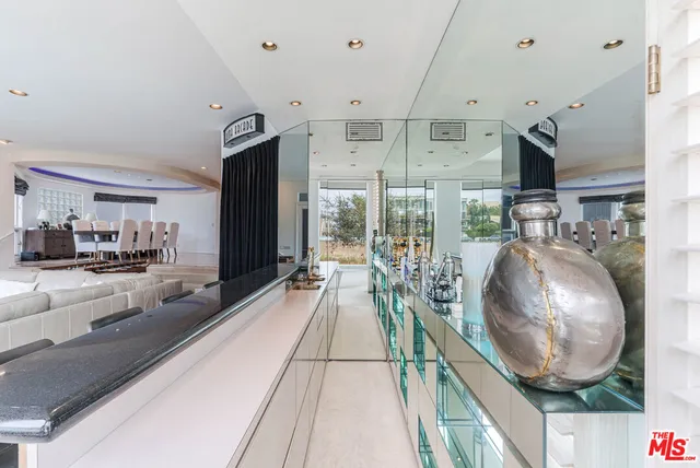 a kitchen with stainless steel appliances granite countertop a stove a sink dishwasher and cabinets with wooden floor