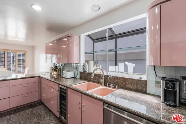 a kitchen with stainless steel appliances granite countertop a sink stove and cabinets