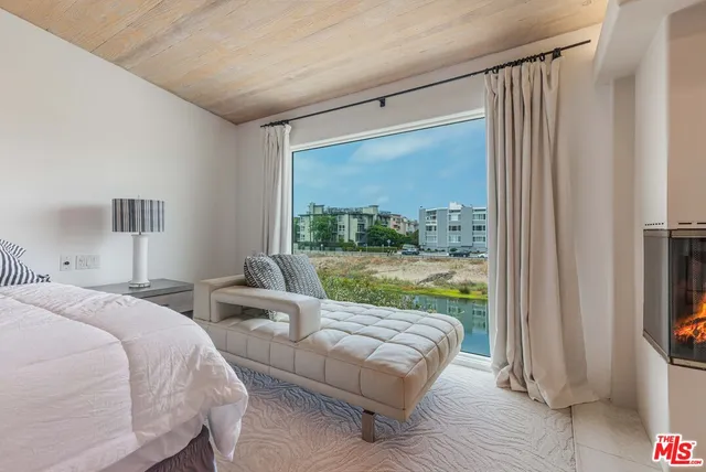 a spacious bedroom with a bed and a couch