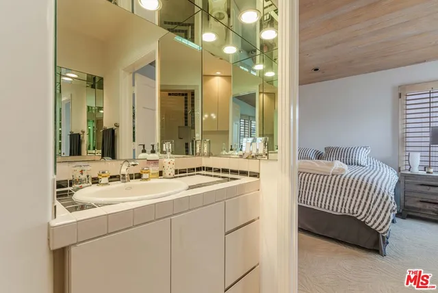 a bedroom with bed and a large window