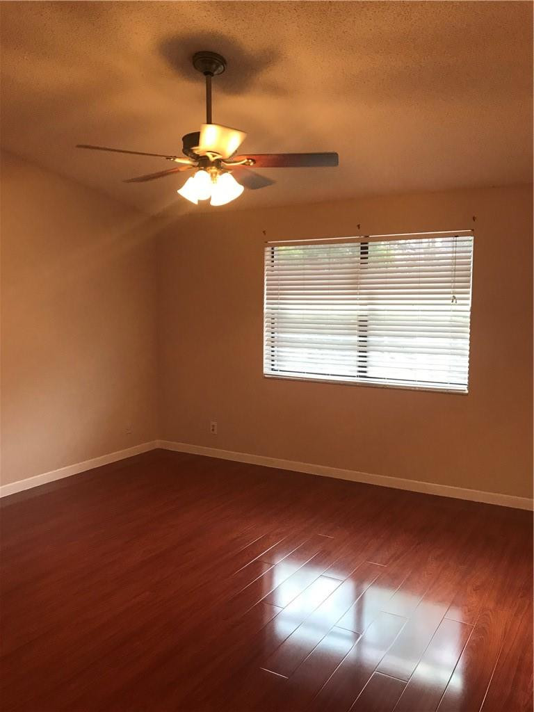 9781 Riverside Drive, Unit 653 Coral Springs, FL 33071 - Photo 14 of 19 a view of empty room with wooden floor and fan