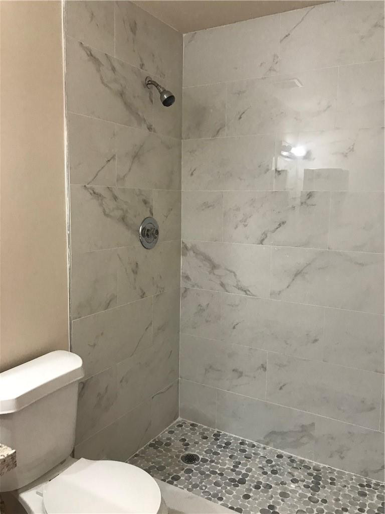 9781 Riverside Drive, Unit 653 Coral Springs, FL 33071 - Photo 17 of 19 a bathroom with a toilet and a shower