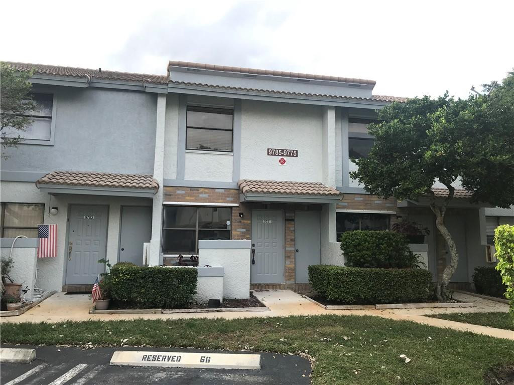 9781 Riverside Drive, Unit 653 Coral Springs, FL 33071 - Photo 2 of 19 a front view of a house with garden