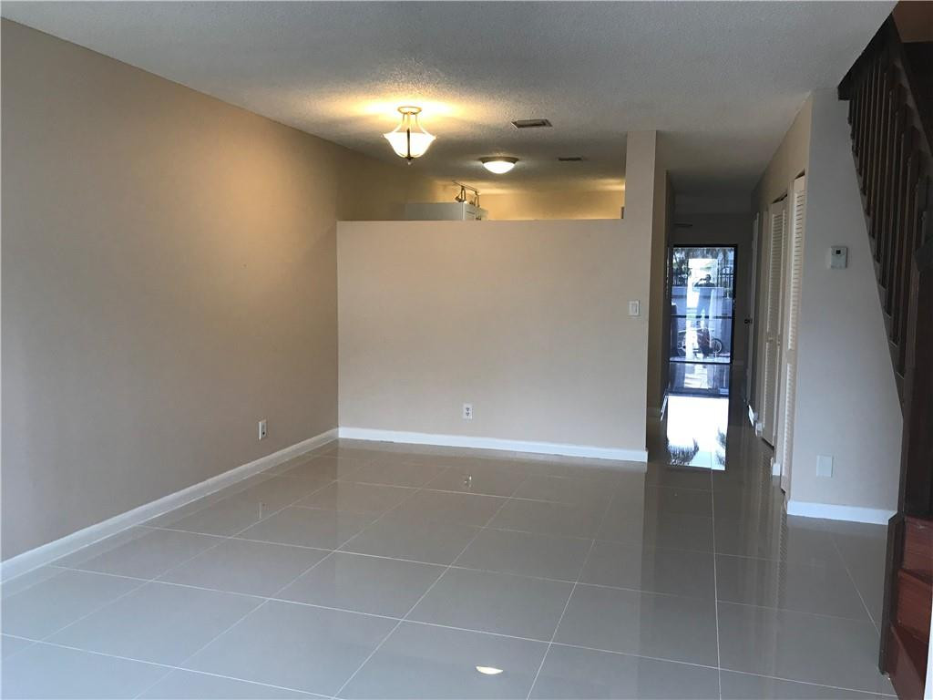 9781 Riverside Drive, Unit 653 Coral Springs, FL 33071 - Photo 4 of 19 an empty room with wooden floor and windows