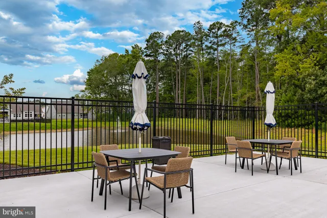 a view of a deck with a table chairs and a backyard