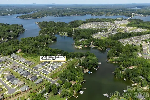 an aerial view of residential houses with outdoor space and river