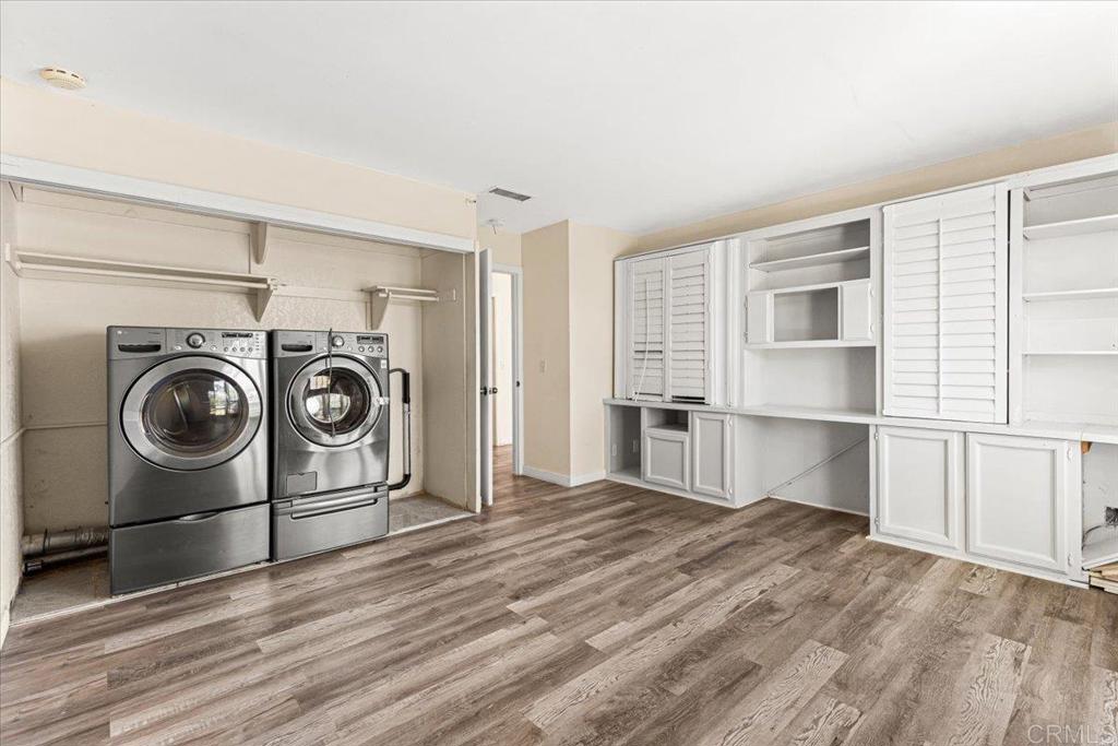 25175 Hereford Drive Ramona, CA 92065 - Photo 22 of 25 a view of a kitchen with a stove fridge and wooden floor