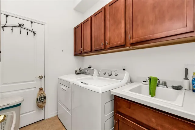 a utility room with sink dryer and washer