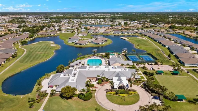 an aerial view of a house swimming pool and outdoor seating