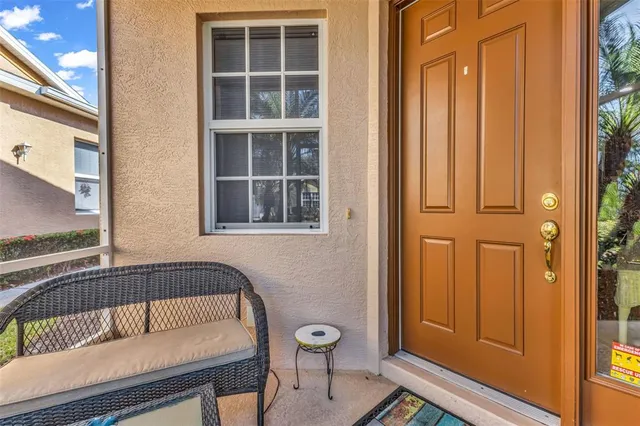 a view of a door and wooden floor in a corridor