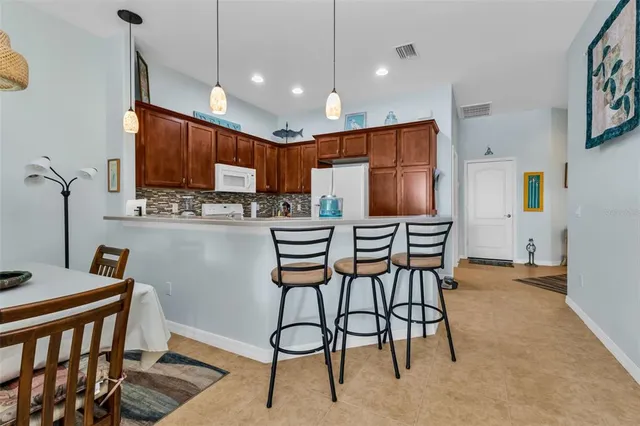 a kitchen with stainless steel appliances kitchen island granite countertop a sink and cabinets