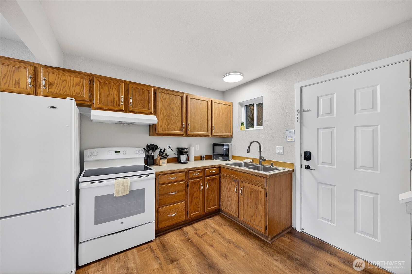 5972 Hastings Road Clinton, WA 98236 - Photo 21 of 40 a kitchen with stainless steel appliances granite countertop a stove a sink dishwasher and a refrigerator
