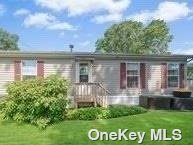 1661-196 Old Country Road Riverhead, NY 11901 - Photo 2 of 2 a front view of house with yard and green space