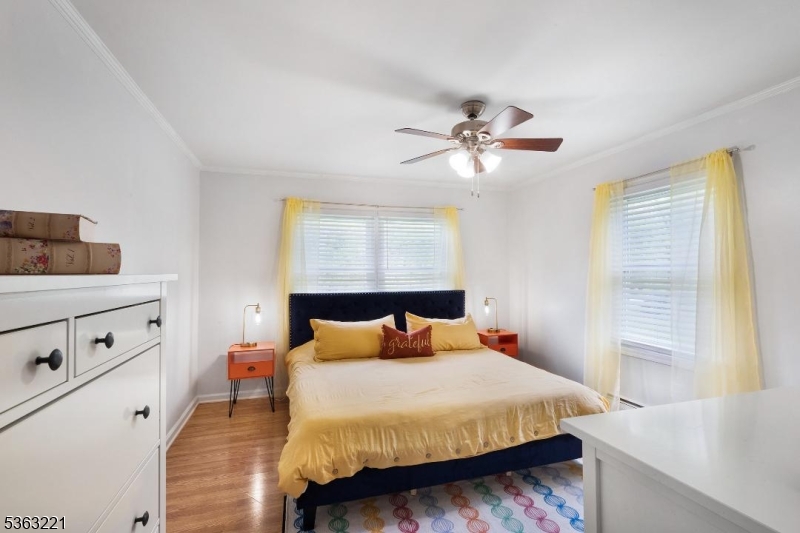 4 Grove Street Newton, NJ 07860 - Photo 10 of 24 a bedroom with a bed and a chandelier