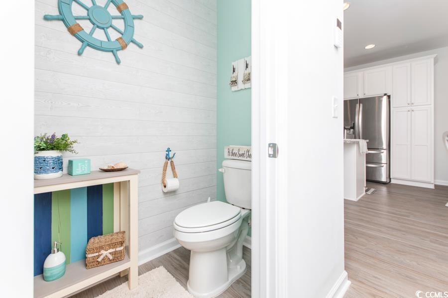 131 Machrie Loop, Unit A Myrtle Beach, SC 29588 - Photo 12 of 40 Bathroom featuring wood-type flooring, wooden wall