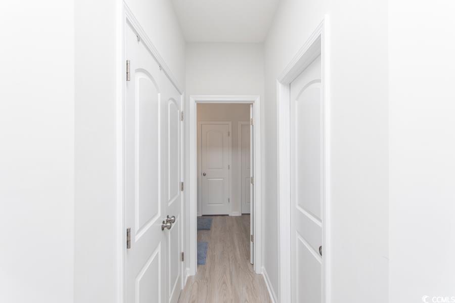 131 Machrie Loop, Unit A Myrtle Beach, SC 29588 - Photo 16 of 40 Hallway featuring light hardwood / wood-style floo