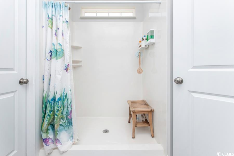 131 Machrie Loop, Unit A Myrtle Beach, SC 29588 - Photo 21 of 40 Bathroom featuring a shower with shower curtain