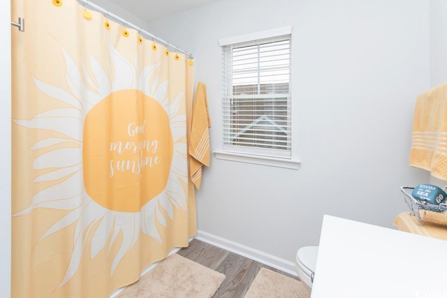 131 Machrie Loop, Unit A Myrtle Beach, SC 29588 - Photo 32 of 40 Bathroom with hardwood / wood-style flooring and t