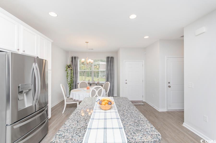 131 Machrie Loop, Unit A Myrtle Beach, SC 29588 - Photo 4 of 40 Kitchen featuring stainless steel fridge, white ca