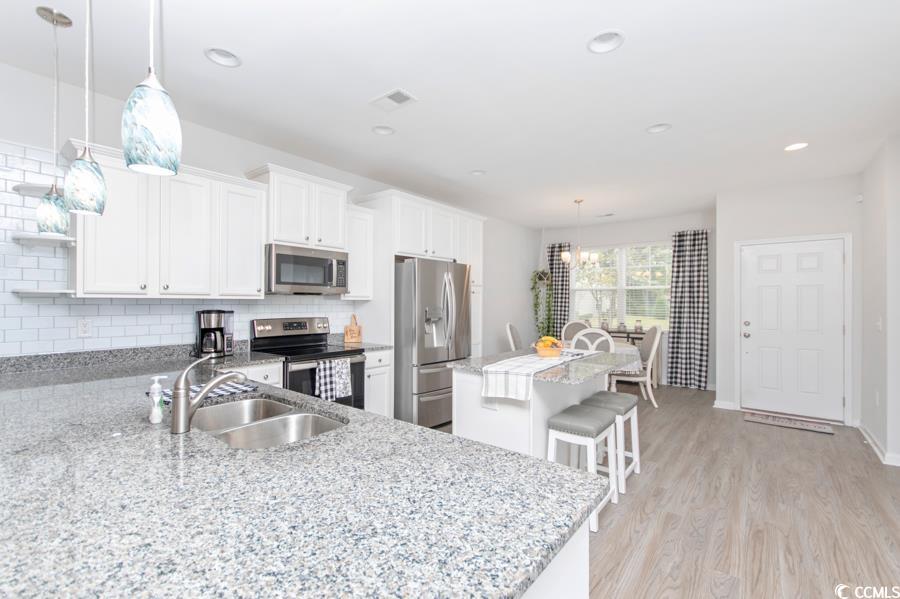 131 Machrie Loop, Unit A Myrtle Beach, SC 29588 - Photo 7 of 40 Kitchen featuring pendant lighting, sink, light ha