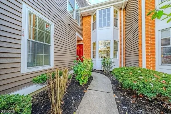 a large kitchen with stainless steel appliances a refrigerator a sink dishwasher a oven and a dining table with wooden floor