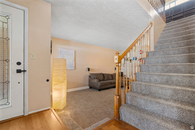165 Pheasantbrook Drive Centerville, UT 84014 - Photo 9 of 30 Stairs featuring wood finished floors, carpet flooring, and a textured ceiling
