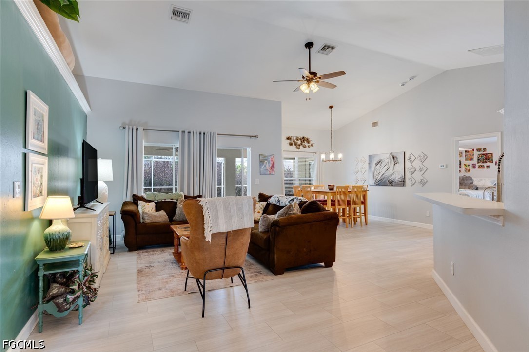 3801 28th Street Southwest Lehigh Acres, FL 33976 - Photo 4 of 37 a living room with furniture and a chandelier