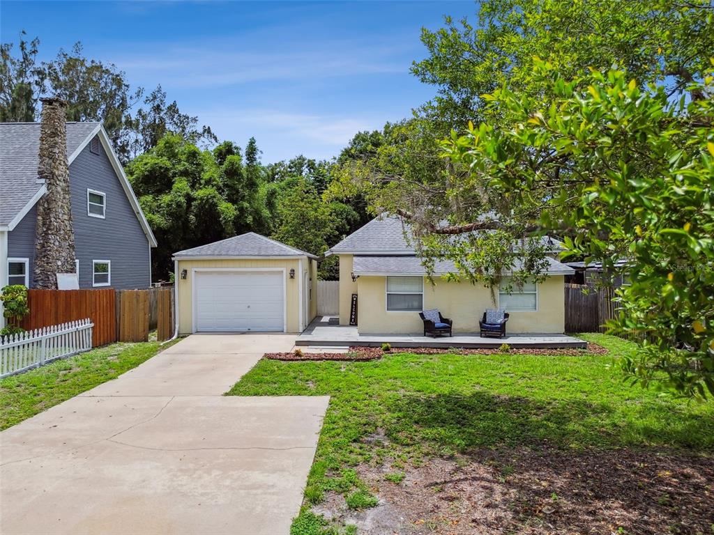 a front view of a house with a yard and a porch
