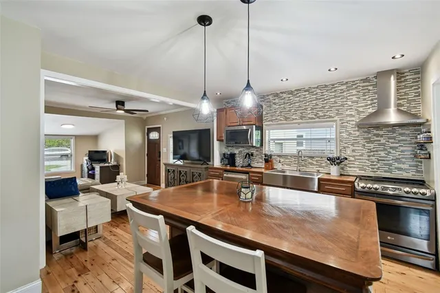 a kitchen with stainless steel appliances granite countertop a stove a sink and a refrigerator