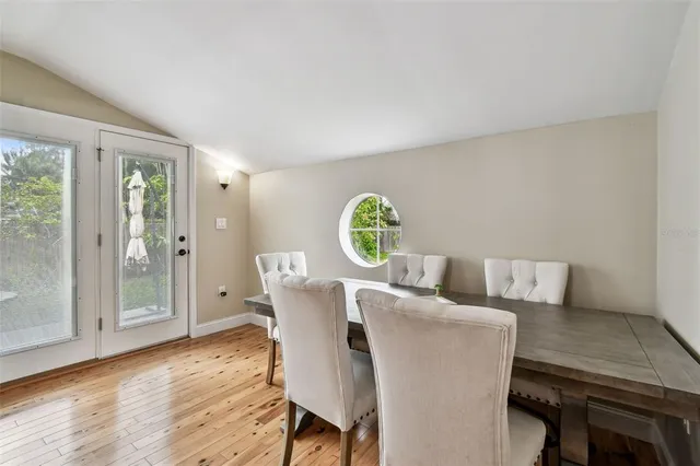 a view of a dining room with furniture and wooden floor
