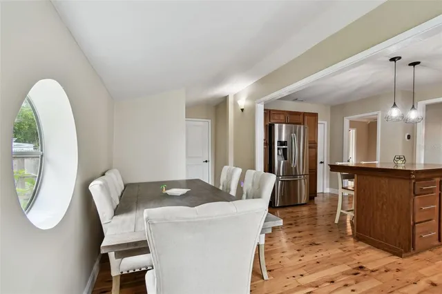 a living room with furniture a mirror and a dining table