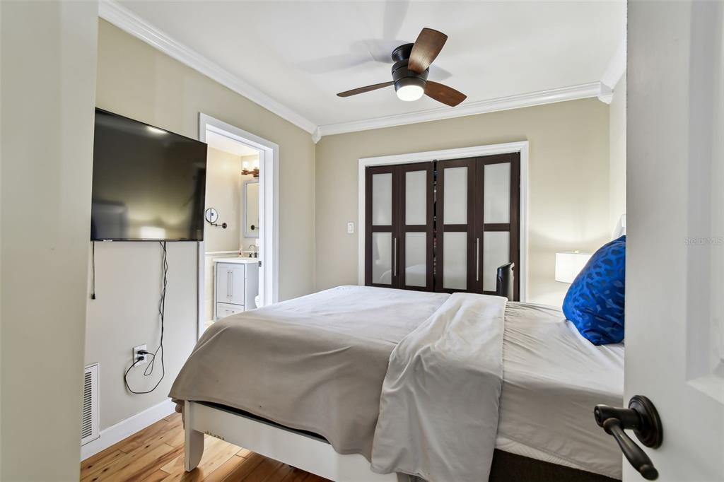 1722 Albemarle Road Clearwater, FL 33764 - Photo 23 of 50 a bedroom with a bed and a flat screen tv