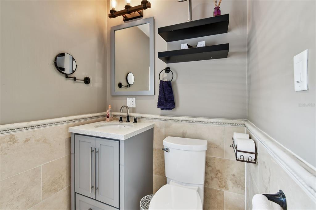 1722 Albemarle Road Clearwater, FL 33764 - Photo 25 of 50 a bathroom with a toilet a sink and a mirror