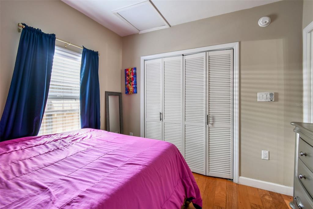 1722 Albemarle Road Clearwater, FL 33764 - Photo 29 of 50 a bed sitting in a bedroom next to a window and a wooden floor