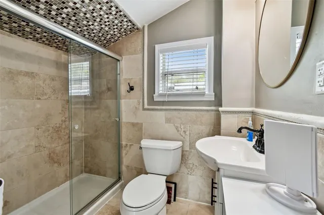 a bathroom with a toilet sink and shower