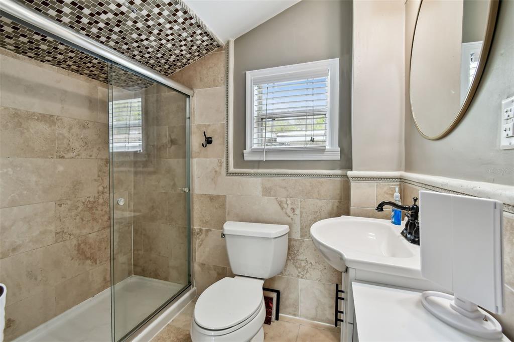 1722 Albemarle Road Clearwater, FL 33764 - Photo 31 of 50 a bathroom with a toilet sink and shower