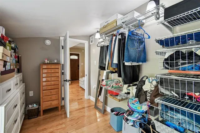 a view of walk in closet with clothes
