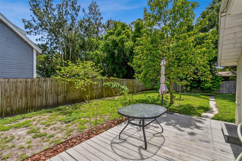 1722 Albemarle Road Clearwater, FL 33764 - Photo 38 of 50 a view of a backyard with table and chairs with wooden fence and plants