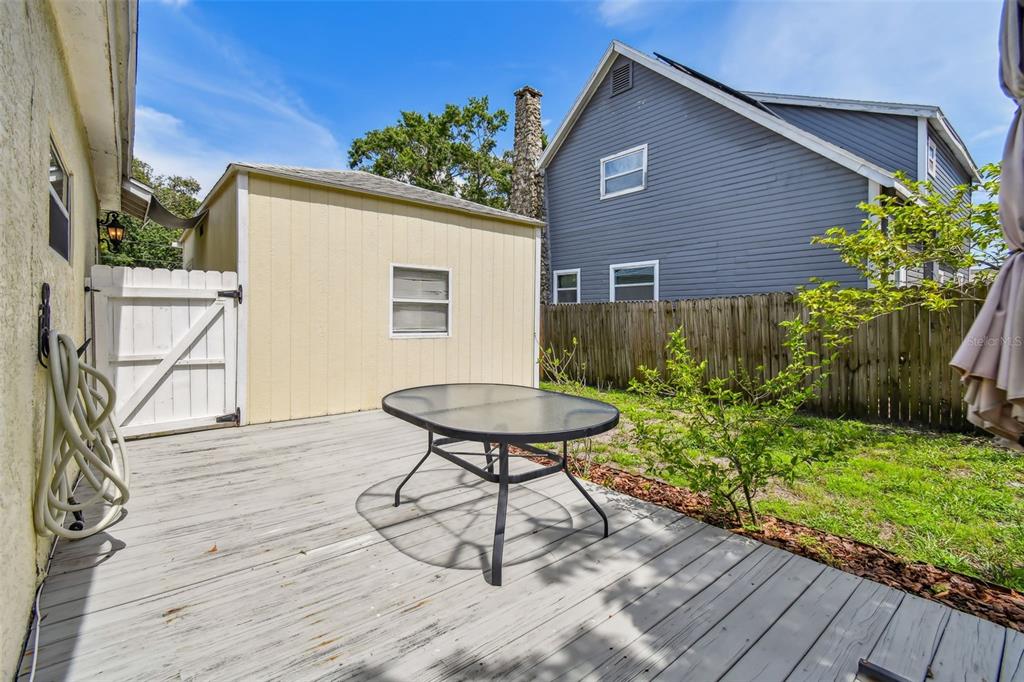 1722 Albemarle Road Clearwater, FL 33764 - Photo 44 of 50 a backyard of a house with plants and wooden fence