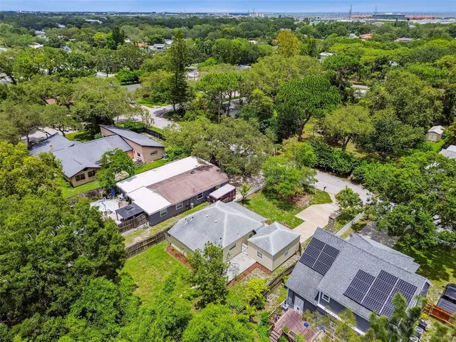 an aerial view of a house with a yard
