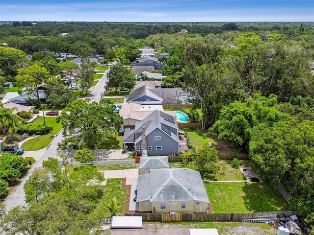 an aerial view of a house with a yard