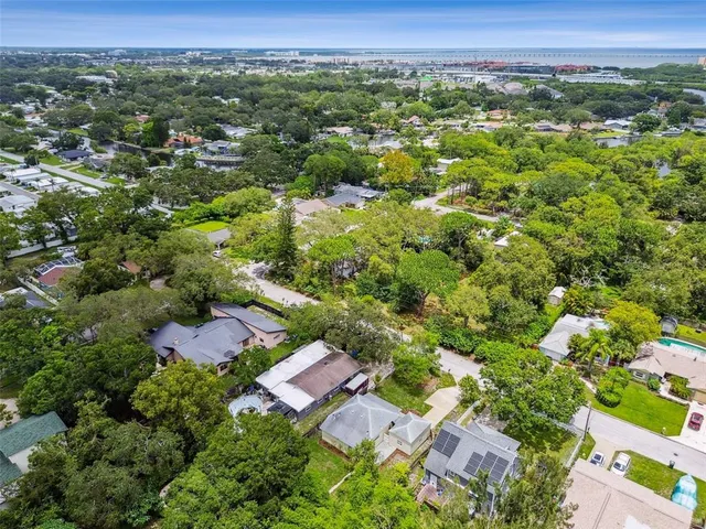an aerial view of a house with swimming pool and big yard