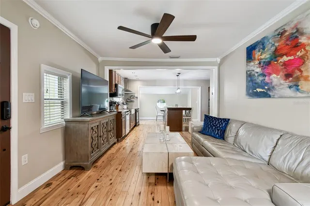 a living room with furniture and a wooden floor