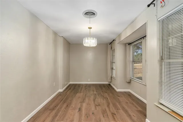 a view of a room with wooden floor and window