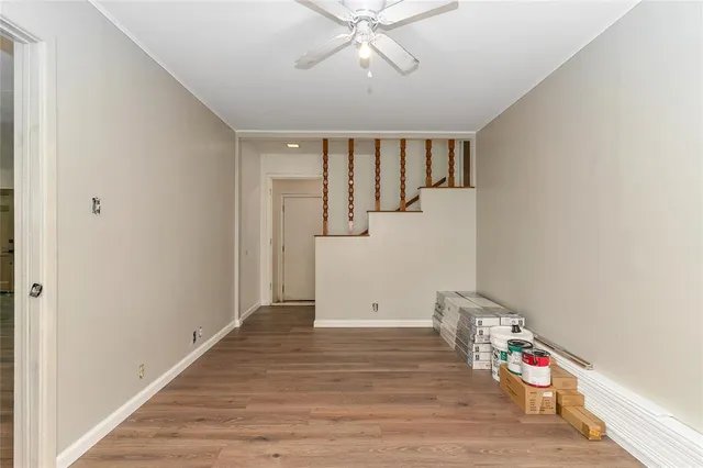 a room with wooden floor and white walls