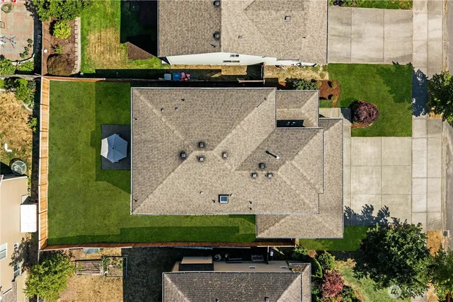 an aerial view of a house with a yard
