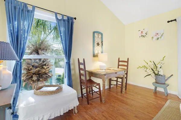 a view of a dining room with furniture window and wooden floor